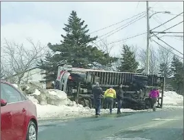  ?? CP PHOTO ?? A truck lies on its side in Paradise, N.L., on Saturday after being blown over by a strong windstorm.