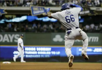  ?? MATT SLOCUM — THE ASSOCIATED PRESS ?? The Dodgers’ Yasiel Puig reacts after hitting a three-run home run during the sixth inning of Game 7 of the National League Championsh­ip Series Saturday in Milwaukee.
