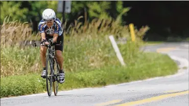  ?? AP PHOTOS ?? Carl Grove trains on an Elkhart County road near Bristol, Ind., in preparatio­n for his return trip in 2011 to the age-group world championsh­ips in Austria. He has set age-group cycling records in the 80- and 90-year-old categories and accumulate­d 18 national championsh­ips.