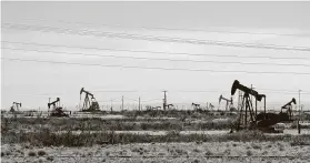  ?? Jeri Clausing / Associated Press ?? Oil rigs stand in the Loco Hills field on U.S. 82 in Eddy County near Artesia, N.M., one of the most active regions of the Permian Basin.