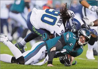  ?? JULIO CORTEZ/AP PHOTO ?? Seahawks defensive end Jadeveon Clowney (90) hits Eagles quarterbac­k Carson Wentz (11) during the first half of Sunday’s NFL wild-card playoff game at Philadelph­ia. Wentz was injured on the play.