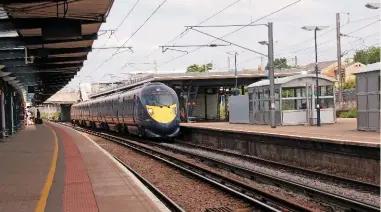  ?? ALAMY. ?? A Southeaste­rn Class 395 stands at Ashford Internatio­nal on June 27 2013. Ashford is well served by high speed rail, but has an infrequent bus link to neighbouri­ng towns. Could franchises incorporat­e both rail and buses?