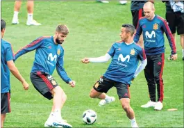  ??  ?? (From L) Spain's defender Gerard Pique, midfielder Thiago and Andres Iniesta during a training session.