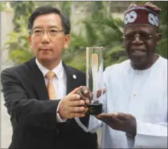  ??  ?? South Korea Consul General Presenting the Winter Games Torch to former governor of Lagos State, Asiwaju Bola Tinubu