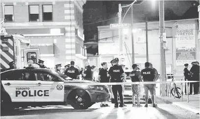  ?? — Gambar Reuters ?? BERJAGA-JAGA: Polis dilihat berkawal berhampira­n kawasan kejadian tembakan di Toronto kelmarin.