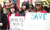  ?? ASHLEE REZIN/ SUN- TIMES ?? Protesters hold signs in the lobby of the Thompson Center calling on the Illinois State Board of Education to appoint an independen­t monitor to oversee changes with special education at Chicago Public Schools on Wednesday.