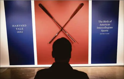  ?? John Minchillo / Associated Press ?? The Harvard-Yale Regatta 1852 Trophy Oars are displayed before an auction on Thursday at Sotheby’s in Manhattan.