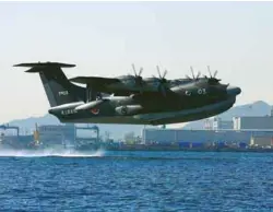  ??  ?? (Top) Prime Minister Modi and Prime Minister of Japan Abe witnessing the exchange of the civil nuclear agreement between India and Japan at Kantei in Tokyo on November 11; (above) ShinMaywa US-2 amphibious aircraft.