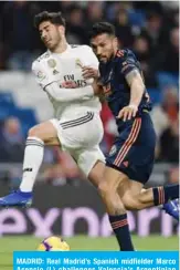  ??  ?? MADRID: Real Madrid’s Spanish midfielder Marco Asensio (L) challenges Valencia’s Argentinia­n defender Ezequiel Garay during the Spanish league football match between Real Madrid and Valencia at the Santiago Bernabeu stadium in Madrid on Saturday. — AFP