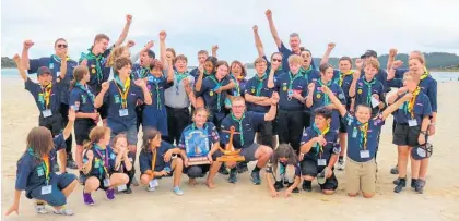  ?? Photo / Rebecca Payne ?? Scouts and Venturers from Kirikiriro­a & St Peter’s Scout Group in Hamilton with their haul of nine pennants, and two trophies won in the Northland Regatta.