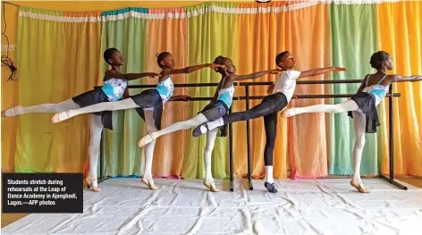  ?? —AFP photos ?? Students stretch during rehearsals at the Leap of Dance Academy in Ajangbadi, Lagos.