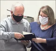  ?? Jeremy stewart ?? Polk County Board of Education member Tommy Sanders (left) receives a certificat­e of recognitio­n from Superinten­dent Laurie Atkins during last Tuesday’s meeting of the school board. Sanders is in his 30th year as a member of the board.