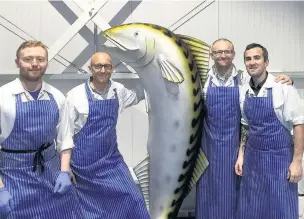  ??  ?? Tom Levings (centre right) and Graeme Humphrey (centre left), of Big Fish Little Fish wholesaler­s are to reopen Evans of Didsbury as a fishmonger­s