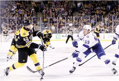  ?? — AFP ?? BOSTON: Jake Dotchin #59 of the Tampa Bay Lightning defends David Backes #42 of the Boston Bruins during the third period at TD Garden on April 4, 2017 in Boston, Massachuse­tts. The Bruins defeat the Lightning 4-0.