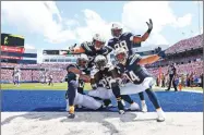  ?? AP ?? PHOTO BY RICH BARNES Los Angeles Chargers' Melvin Gordon, center celebrates his touchdown with teammates during the first half against the Buffalo Bills, Sunday, Sept. 16 in Orchard Park, N.Y.