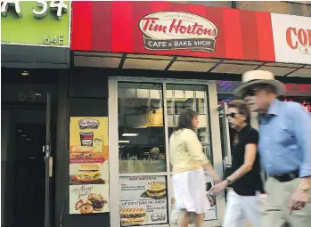  ?? SPENCER PLATT/GETTY IMAGES FILES ?? Tim Hortons’s U.S. franchisee­s say Restaurant Brands has diverted ad funding to other purposes, intimidate­d store owners and increased costs for key products such as coffee and bacon. Restaurant Brands pledged to work closely with them in the U.S.