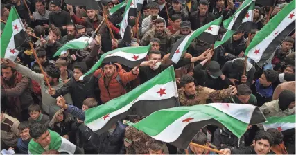  ?? AAREF WATAD/AFP VIA GETTY IMAGES ?? Syrians mark 13 years since pro-democracy protests swept the country, in the rebel-held city of Idlib on Friday. Government suppressio­n of the uprising set off a civil war that has killed more than half a million people.