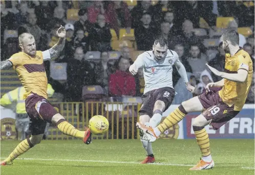  ??  ?? 0 Hearts full-back Michael Smith fires home an inch perfect shot from the edge of the box to open the scoring at Fir Park last night.