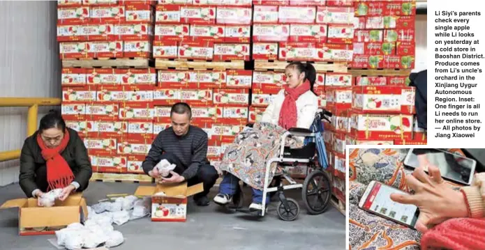  ??  ?? Li Siyi’s parents check every single apple while Li looks on yesterday at a cold store in Baoshan District. Produce comes from Li’s uncle’s orchard in the Xinjiang Uygur Autonomous Region. Inset: One finger is all Li needs to run her online store. — All photos by Jiang Xiaowei