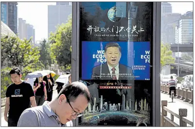  ?? AP/ANDY WONG ?? An electronic panel in Beijing shows video of Chinese President Xi Jinping speaking Wednesday at the World Economy Forum. U.S. Commerce Secretary Wilbur Ross is to travel to China this weekend for trade-dispute talks.