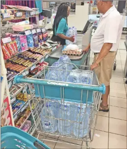  ??  ?? Customers at supermarke­ts have been stocking up on bottled water and the price has risen at one national retail chainstore.