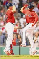  ?? Adam Glanzman / Getty Images ?? Rafael Devers, right, celebrates his solo homer in the third inning with teammate Hunter Renfroe against the Phillies at Fenway Park Friday.