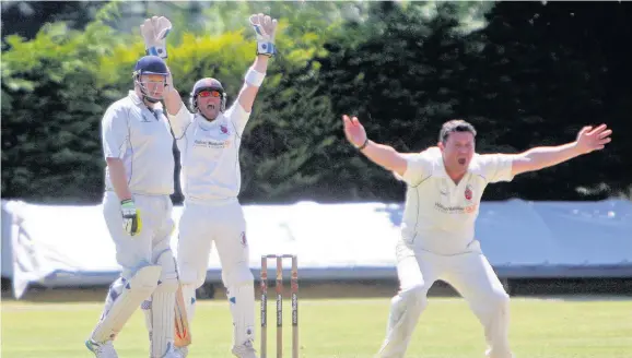  ??  ?? Hawarden batsman Ian Martin looks on as Bangor bowler Andy Williams successful­ly appeals for an LBW.