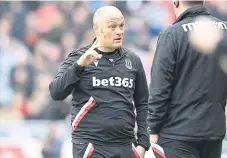  ?? ?? Stoke boss Alex Neil makes a point to the fourth official.