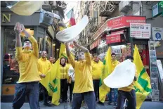  ?? — AFP ?? Members of the Pizzaioli Acrobats Coldiretti perform “twirling” pizza to celebrate the Unesco decision to make the art of Neapolitan “Pizzaiuolo” an “intangible heritage” on in Naples.