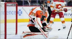  ?? MATT SLOCUM - THE ASSOCIATED PRESS ?? Flyers goalie Carter Hart blocks a shot during the first period Tuesday night against the Calgary Flames at Wells Fargo Center.