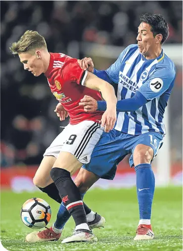  ??  ?? United’s Scott Mctominay is challenged by Brighton striker Leonardo Ulloa at Old Trafford REF WATCH: ANDRE MARRINER
NEMANJA MATIC