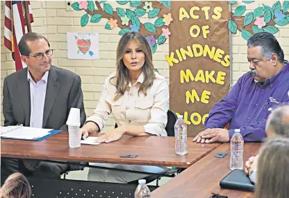  ??  ?? Melania Trump, the US first lady, meets staff at the Upbring New Hope Children’s Centre in Texas. The Zara jacket that she wore, below left, created some controvers­y due to the slogan written on the back, below right