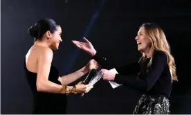  ??  ?? The Duchess of Sussex presents the UK designer of the year womenswear award to Clare Waight Keller. Photograph: Joe Maher/BFC/Getty Images