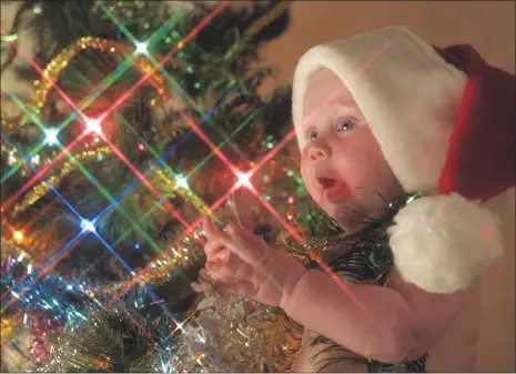  ??  ?? Not all the children in South Africa are as lucky as this little one who gets to celebrate Christmas with a loving family.