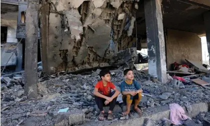  ?? Abed/AFP/Getty Images ?? Children sit amid the rubble of a building in the aftermath of an Israeli strike in Rafah in the southern Gaza Strip. Photograph: Mohammed
