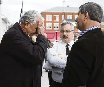  ?? PHOTOS BY PHIL SKINNER/PSKINNER@AJC.COM ?? Locust Grove Mayor Robert Price (from left) reacts to one of his officers being killed as he talks with Henry County Chief Deputy David Foster and McBrayer. McBrayer said his deputies had no reason to believe the suspect was dangerous when they arrived...