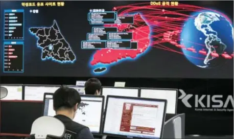  ?? YUN DONG-JIN — YONHAP VIA AP, FILE ?? In this Monday file photo, employees watch electronic boards to monitor possible ransomware cyberattac­ks at the Korea Internet and Security Agency in Seoul, South Korea. Unable to rely on good human behavior, computer security experts are developing...