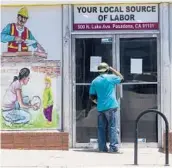  ?? DAMIAN DOVARGANES/AP 2020 ?? A man looks inside a job center. The United States still has 8.4 million fewer jobs than it had in February 2020, just before the pandemic struck.