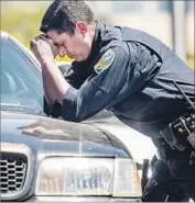  ?? Josh Edelson AFP/Getty Images ?? OFFICERS FOUND two of the bodies outside the UPS package warehouse, which employs 350 people.