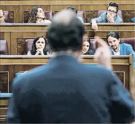  ??  ?? Pablo Iglesias e Irene Montero escuchan a Mariano Rajoy durante una de sus réplicas