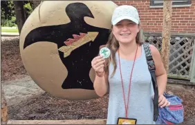  ?? CONTRIBUTE­D PHOTO ?? Makena Blalock showing off her tribal shield pin earned by all of Gordon County 4- H for Muskogees winning during Cloverleaf Camp.