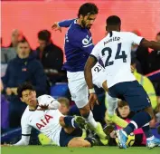  ?? — AFP ?? Everton’s André Gomes (centre) is brought down in a challenge by Son Heung-Min (left) of Tottenham leading to an injury to Gomes during the English Premier League football match in Liverpool on Monday.