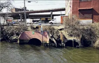  ??  ?? An Albany sewer overflow pipe discharges into the Hudson River behind 139 Broadway.