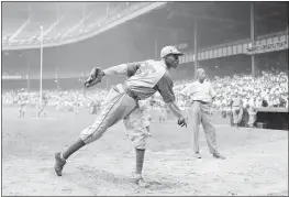  ?? MATTY ZIMMERMAN — THE ASSOCIATED PRESS, FILE ?? Kansas City Monarchs pitcher Leroy Satchel Paige warms up at New York’s Yankee Stadium before a Negro League game against the New York Cuban Stars in 1942.