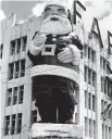  ??  ?? Santa beckons from the Farmers' Trading Company building in 1961.