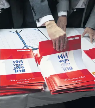  ??  ?? GEARING UP: Pheu Thai Party faithful hand out party literature ahead of the poll. The major parties are releasing policy gradually, but agree they will have to make a bigger effort to reach out to a diversifyi­ng electorate.