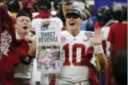  ?? BUTCH DILL — THE ASSOCIATED PRESS ?? Alabama quarterbac­k Mac Jones celebrates with fans after defeating Clemson in the Sugar Bowl semifinal playoff game on Jan. 1.