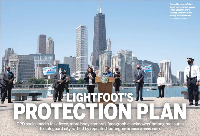  ?? PAT NABONG/SUN-TIMES ?? Flanked by other officials, Mayor Lori Lightfoot speaks Friday about the city’s strategy to curtail recent looting and lawlessnes­s.