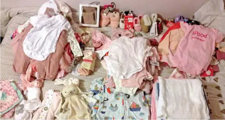  ??  ?? Pink theme: Some of the clothes Annie Lightfoot collected when she thought she was expecting a baby girl
