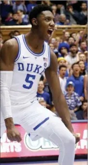  ?? CHRIS SEWARD — THE ASSOCIATED PRESS ?? Duke’s RJ Barrett (5) celebrates after a score while North Carolina State’s Torin Dorn (2) looks on during the second half of an NCAA college basketball game in Durham, N.C., Saturday.